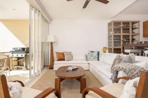 a living room with a white couch and a table at Luxury Oceanview Condo Steps to El Anclote in Punta Mita