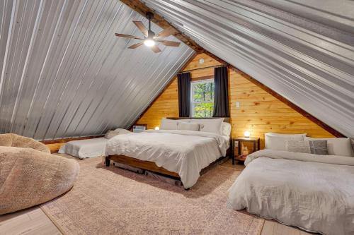 a bedroom with two beds and a ceiling fan at The Elk Camp in Benezette