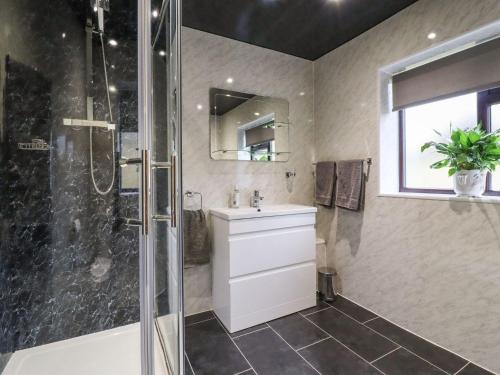 a bathroom with a sink and a shower at Baywood Cottage in Keighley