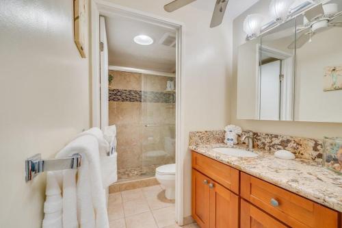 a bathroom with a sink and a toilet and a mirror at Koa Resort 3J · KOA 3J Remodeled 3BD w AC Pool Near Sandy Beach in Kihei