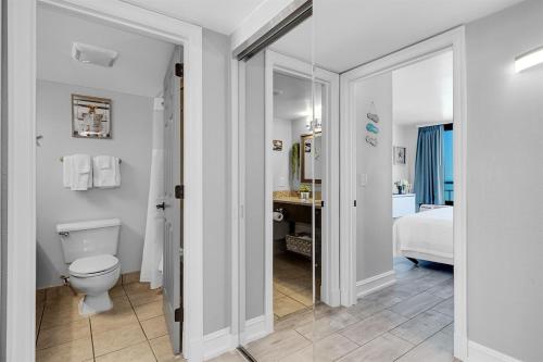 a white bathroom with a toilet and a sink at Gorgeous 1BR Oceanview Suite, Dogs OK 904 in Myrtle Beach
