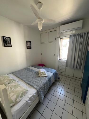 a bedroom with a bed and a ceiling fan at Ametista 2 Beira Mar in Maceió