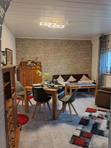 a living room with a table and a couch at Schneeglöckchen in Marl