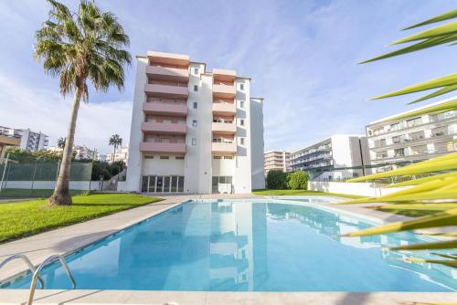 a swimming pool in front of a building at A50 - Castelos Apartment in Portimão in Portimão