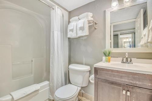 a bathroom with a toilet and a sink and a mirror at Note worthy 1BR Oceanview Dogs OK! 438 in Myrtle Beach