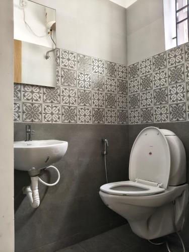 a bathroom with a toilet and a sink at The Loft OMR in Chennai