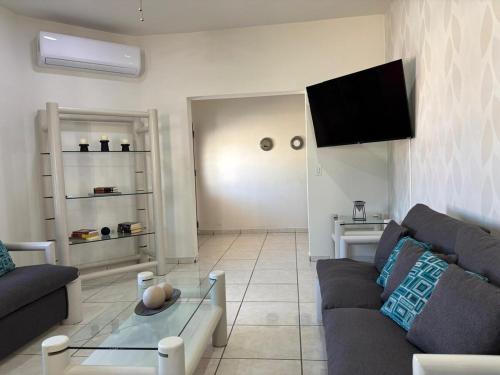 a living room with a couch and a tv at Large house near Plaza Forjadores-Pet friendly in La Paz
