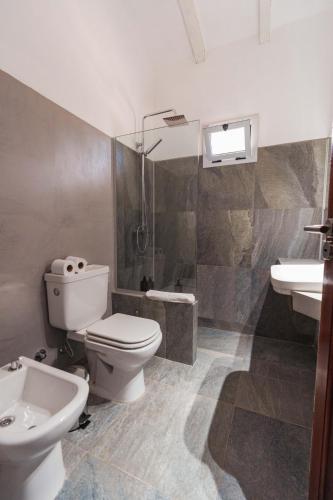 a bathroom with a toilet and a sink and a shower at Madaro House in San Antonio de Arredondo