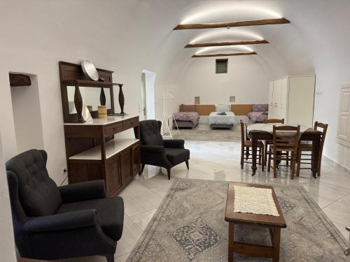 a living room with a table and chairs at Alexander House 1 in Leonidion