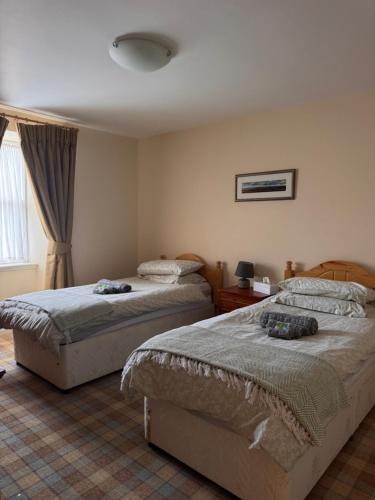 Postel nebo postele na pokoji v ubytování Craiglea Lodge