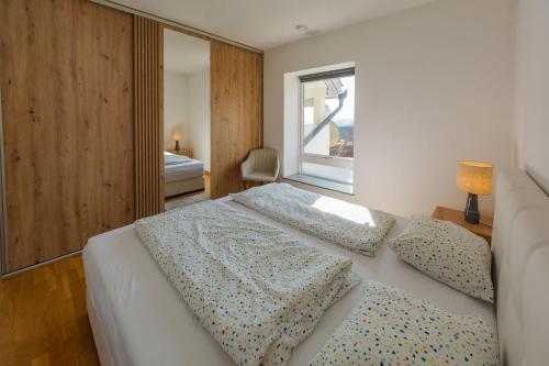 a bedroom with a bed with two pillows and a window at Villa Grande in Odorheiu Secuiesc