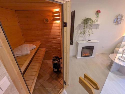 a small room with a sauna with a fireplace at Wellness Minikvítek in Smržovka