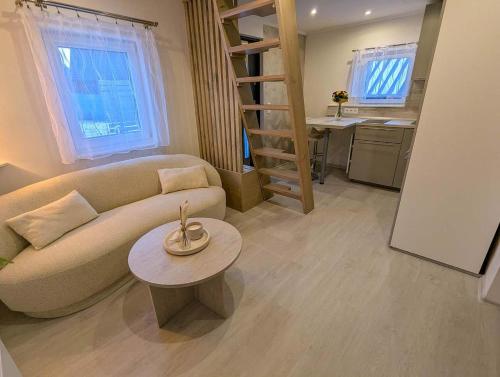 a living room with a couch and a table at Wellness Minikvítek in Smržovka