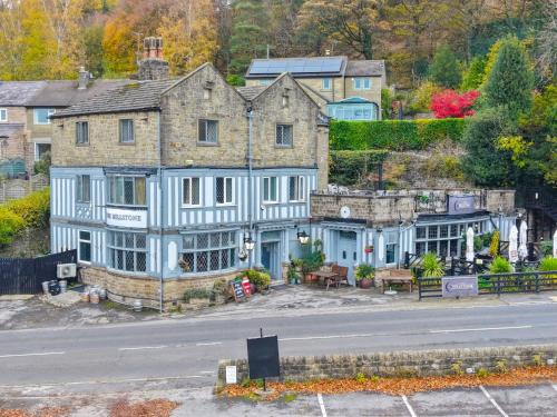 an old house on the side of a road at The Millstone Country Inn in Hathersage