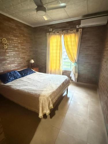 a bedroom with a large bed and a window at Refugio de Santi in Santo Tomé