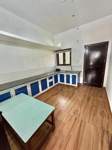 an empty room with a table in the middle of it at Guest arc Residency in Sultan Bathery