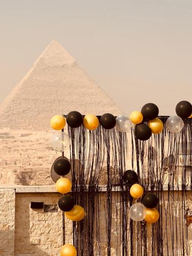 a bunch of balloons in front of a pyramid at Giza Pyramids Inn in Cairo
