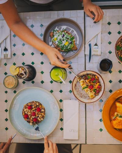 a group of people eating food on a table at Dally Apart Hotel in Rabat