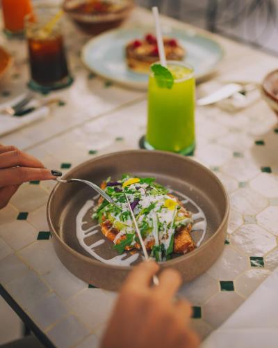 a person eating a bowl of food on a table at Dally Apart Hotel in Rabat
