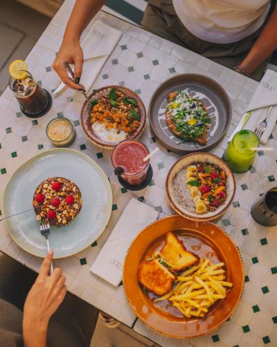 a table with plates of food on it at Dally Apart Hotel in Rabat