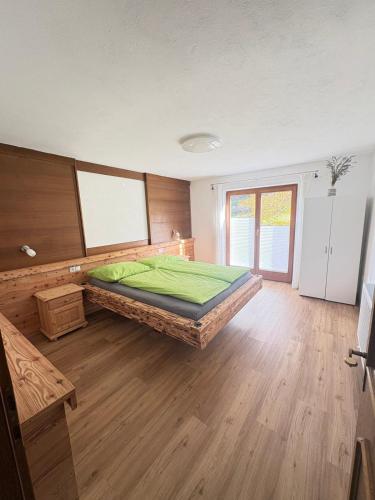a large bedroom with a large green bed in it at Apartment Tirol #Spielanger Hof# in Weer