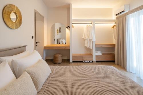 a bedroom with a bed and a mirror in a room at Paizan Homes - Kos City Center Apartments in Kos