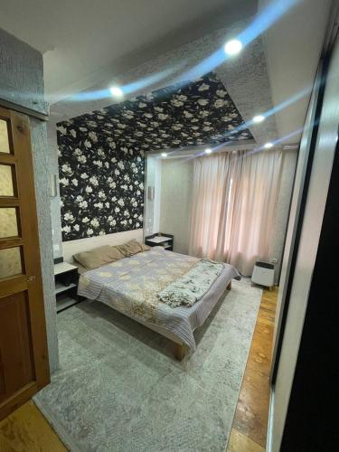 a bedroom with a large bed in a room at CenterHouse1 in Karakol