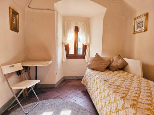 a small bedroom with a bed and a window at Il Leoncino Loft con vista sulla Piazza in Pistoia