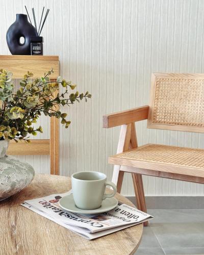a cup of coffee on a table with a chair at Grace Living in Limassol