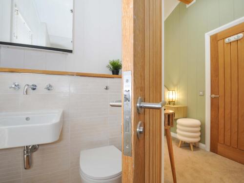 a bathroom with a toilet and a sink at 6 Stonerush Valley in Looe