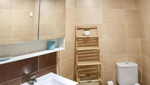 a small bathroom with a sink and a toilet at Ático Formoso in Cee