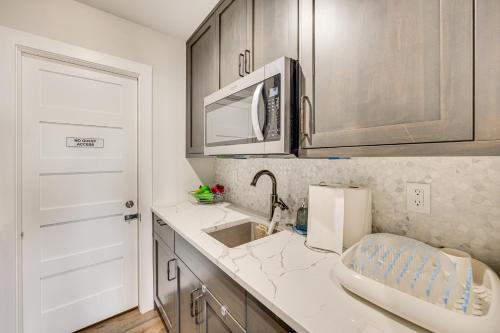 a kitchen with a sink and a microwave at Spacious Southern Colorado Home with Mountain Views in Monument