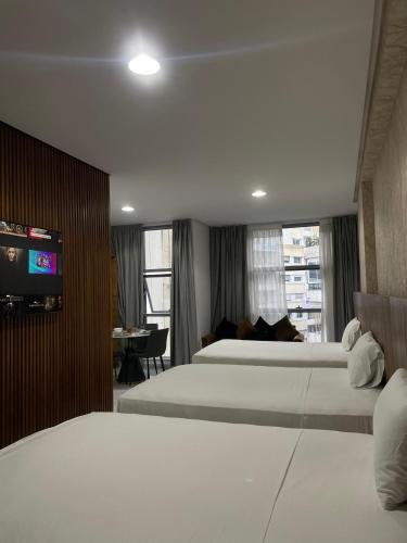 a hotel room with two beds and a flat screen tv at Facelift in Tangier