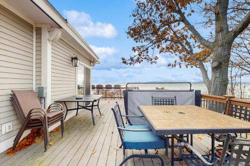 a deck with tables and chairs on a house at Broadlake in Thayer Beach