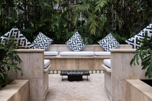 a group of pillows on a bench in a garden at Four Seasons Hotel Mexico City in Mexico City