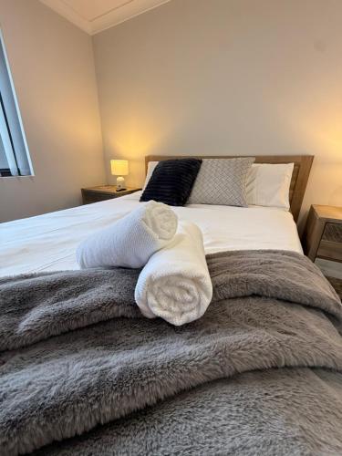 a bedroom with a bed with towels on it at The Margs Hideaway Ensuite in Margaret River Town