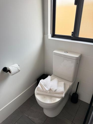 a white toilet in a bathroom with a window at The Margs Hideaway Ensuite in Margaret River Town