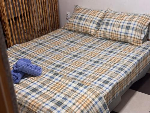 a stuffed animal is sitting on a bed at APARTMAN Pahuljica in Kruševac