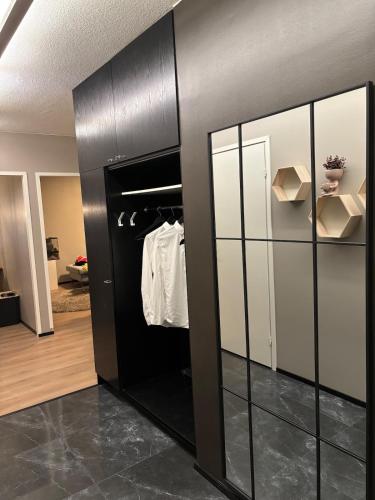 a walk in closet with black and white cabinets at Stylish and cozy apartment in Rovaniemi
