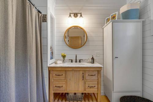 a bathroom with a sink and a mirror at Family Cottage, Sandy Beach & Paddleboards in Meredith