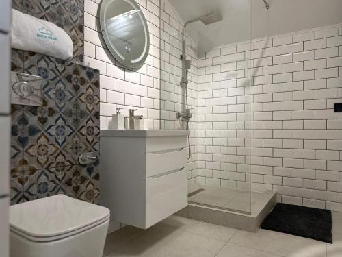 a bathroom with a toilet and a sink and a mirror at Mountain soul hub будиночок на схилі in Krasnik
