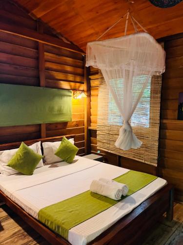 a bedroom with two beds and a window at Soul Villas in Tangalle