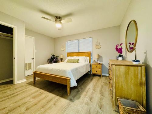 a bedroom with a bed and a ceiling fan at NEW Getaway by Gulfport Beach in Gulfport
