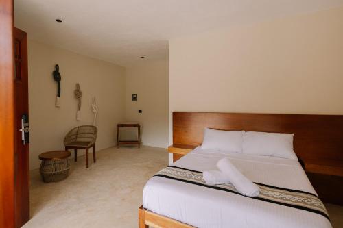 Ένα ή περισσότερα κρεβάτια σε δωμάτιο στο Quietud Hotel