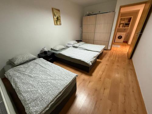 una camera con due letti e un corridoio con una porta di Skyline View Apartment - 15th Floor Bliss a Bratislava