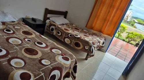 Una cama o camas en una habitación de Hotel EL QUIMBO