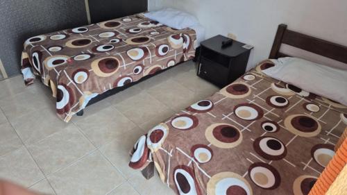 Una cama o camas en una habitación de Hotel EL QUIMBO