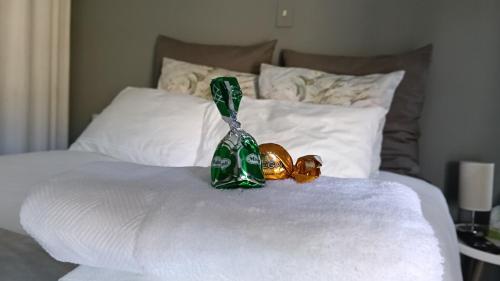 a pair of bells sitting on top of a bed at Fijnbos - Something-Els in Rooiels