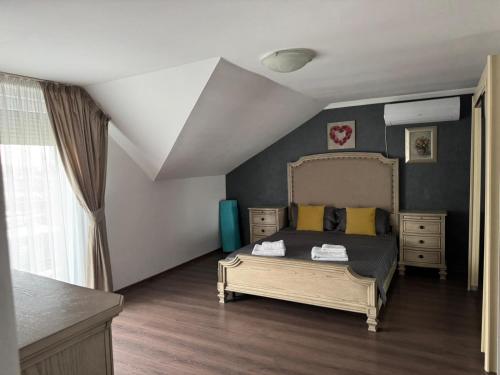 een slaapkamer met een bed met gele kussens bij Casa Rosa by MANAGR in Piatra Neamţ