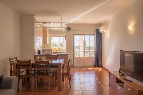 a kitchen and dining room with a table and chairs at B33 - Praia do Vau Apartment in Portimão
